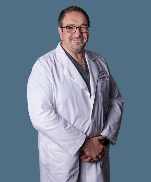 Neil Goldstein, M.D., Vascular Specialist at Pedes Orange County, in a lab coat.