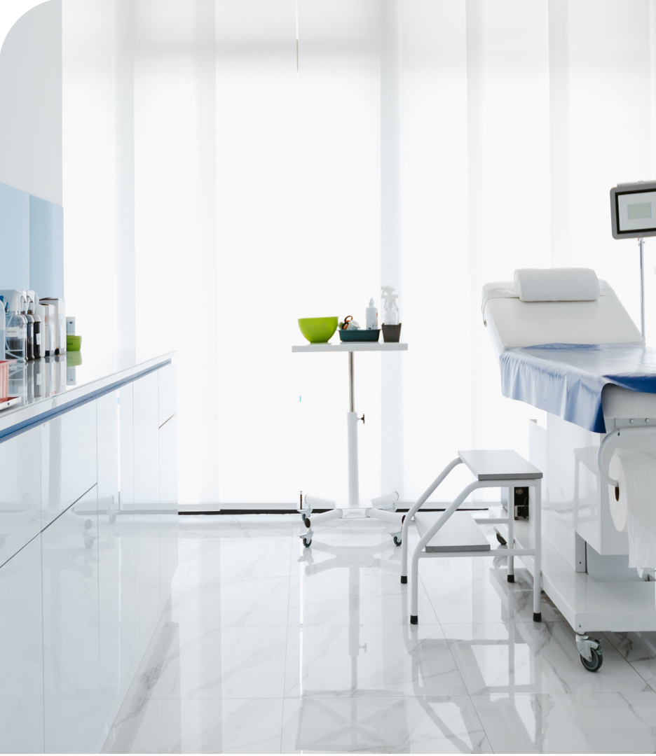 Room in a clinic with a patient bed and monitor for vitals